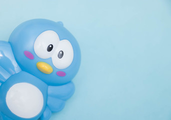 Little baby toy chick close-up on a blue background. fun for young children.