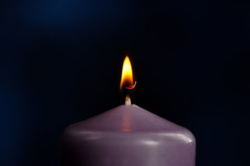 burning purple candle close-up