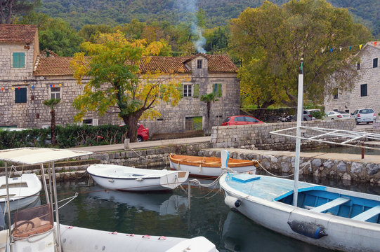 Autumn day in small Mediterranean town. Montenegro, Adriatic Sea, Bay of Kotor.  View of ancient town of Stoliv