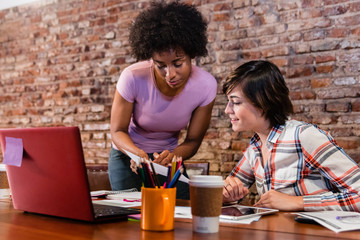 Boss and employee working on business proposal at office