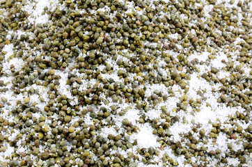 many green capers under salt