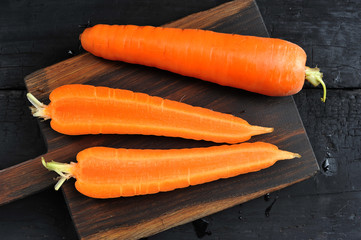 whole and cut in half carrot close-up