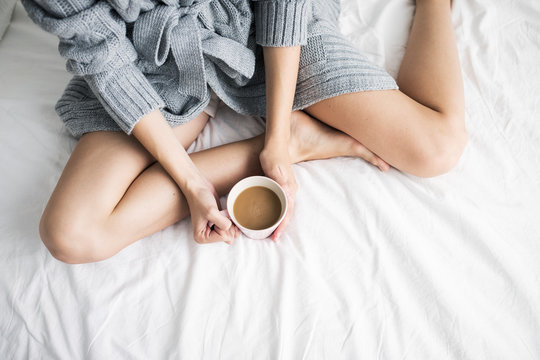 Woman Having Morning Coffee in Bed