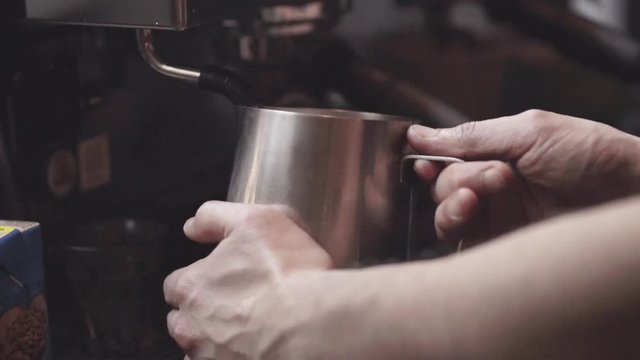 Barista steam ming milk for coffee