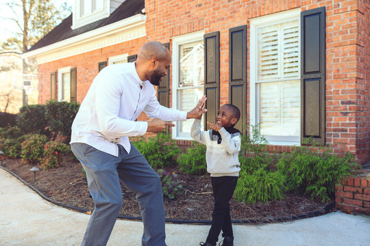 Father and son giving each other a high five