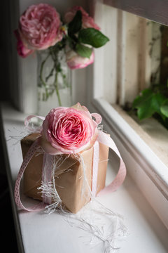 pretty gift with ribbon and pink rose