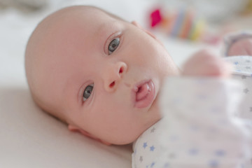 One month baby boy close-up showing tongue