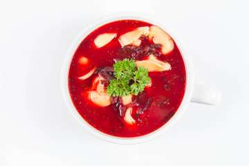 Traditional polish Christmas Eve dish: red borscht with uszka a mushroom filled kind of dumpling decorated with parsley 