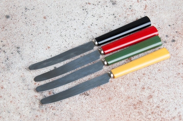 Four vintage knife on concrete background.