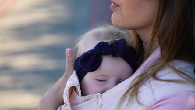 baby sleeping in a sling