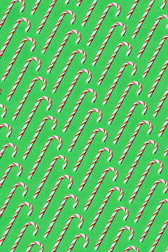 Candy canes pattern on green background
