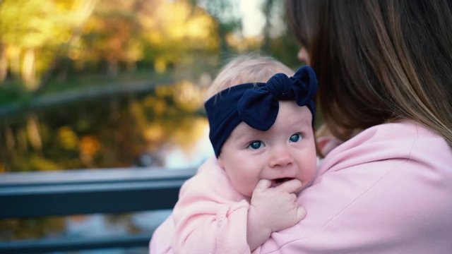 A cute little baby is looking into the camera and is happy