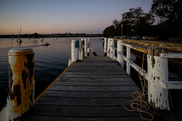 Obraz premium old wooden jetty, sunset, relax, calm, water, sea, boats.