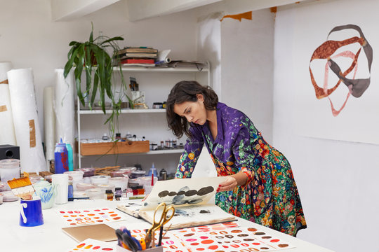 Female Artist Analyzing Illustrations At Studio