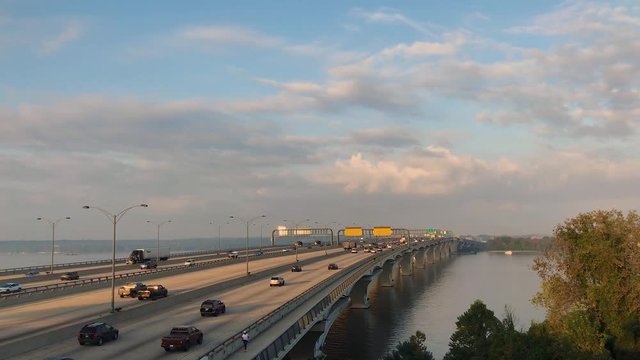 This Ultra High Definition footage is a time lapse of the morning commute over the Woodrow Wilson Bridge, the Capital Beltway; Northwest view. This bridge was filmed during the golden hour.