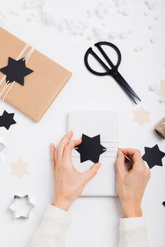 Female hands packaging a present