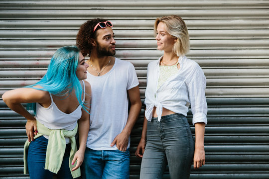 Three cute friends walking in the street