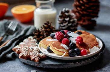 Pile of coconut pancakes with berrys