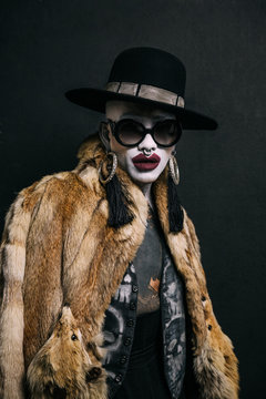 Bizarre fashion studio portrait with extreme makeup