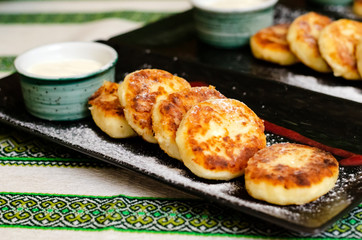 curd pancakes. Cheesecake with sour cream and strawberry sauce. cheese pancakes 