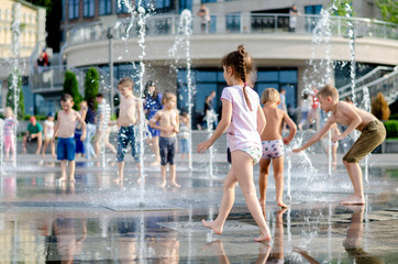 Kyiv, Ukraine - July 13, 2018: A family. summer time. children frolic in the fountain. splashing...