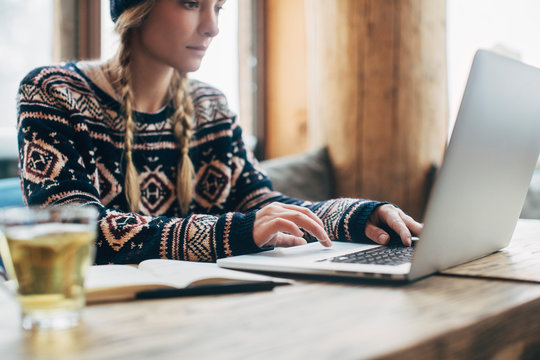 Woman Working on Her Laptop at Log Cabin