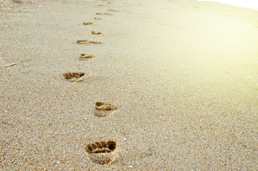 footprints in the sand. children's footprints in the sand on the sea coast. Footstep. summer time. Childhood