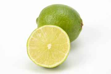 Cut citrus fruit of green lemon on white background