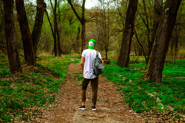 guy with backpack in the woods