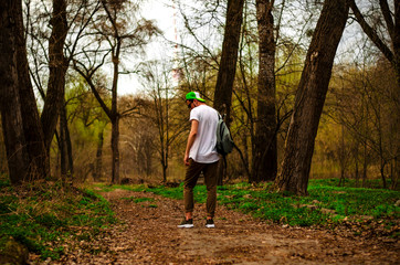 Naklejka na ściany i meble guy with backpack in the woods