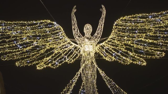 Angel Christmas light decoration at Regent Street, London 2018. It is suspended between buildings. Taken on day of switch on. Lights have a breathing effect. Taken at night.