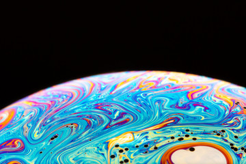 Fototapeta na wymiar Macrophotograph of a colorful soap bubble
