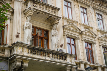 Damaged facade of old building with ornamental elements in the old town, downtown Bucharest, Romania