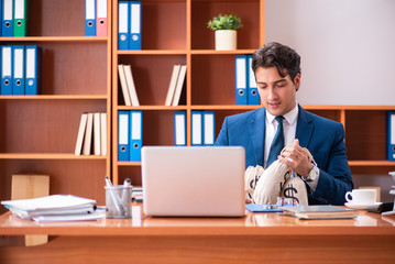 Fototapeta na wymiar Young handsome businessman working in the office