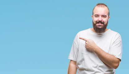 Young caucasian hipster man wearing casual t-shirt over isolated background cheerful with a smile of face pointing with hand and finger up to the side with happy and natural expression on face