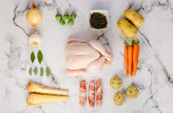 Uncooked ingredients for a roast chicken dinner. 