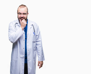 Young caucasian doctor man wearing medical white coat over isolated background looking confident at the camera with smile with crossed arms and hand raised on chin. Thinking positive.