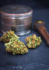 Marijuana buds up close with wooden pipe