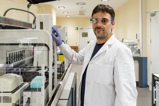 Scientist working with a genome sequencing machine in a DNA laboratory