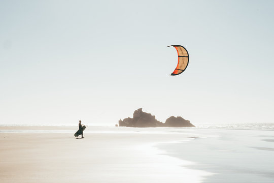 Kitesurfer walking on the beach