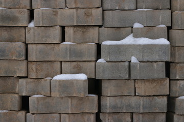 bricks under snow. snow cover stack of brick
