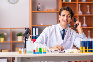 Young handsome biochemist working in the lab 