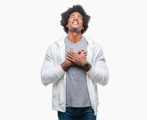 Afro american man wearing sweatshirt over isolated background smiling with hands on chest with closed eyes and grateful gesture on face. Health concept.