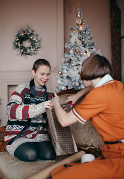 Happy women wrapping present




