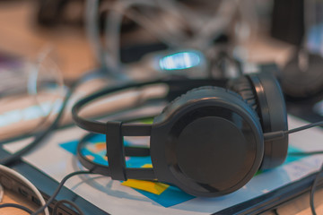 headphone on top of notebook, messy desk