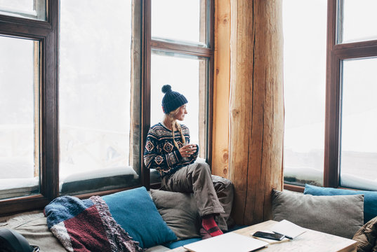 Woman Enjoying Tea in Ski Lodge