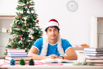 Young student with book at Christmas eve 