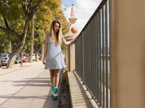 Beautiful woman in rolling skates posing romantically