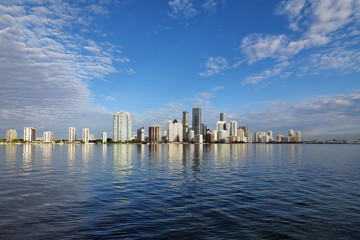 Fototapeta na wymiar Miami, Florida 11-24-2018 The skyline of the City of Miami, Florida, reflected in the calm water of Biscayne Bay in early morning light.