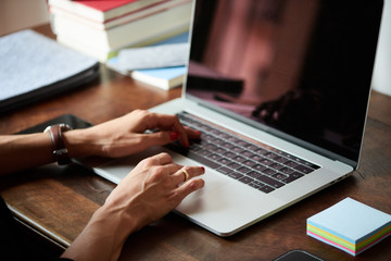 Anonymoua worker using laptop at desk